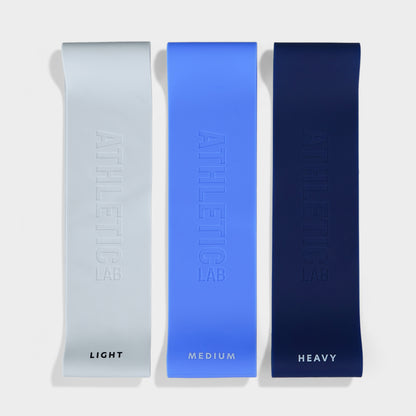 Three resistance bands labeled 'Light', 'Medium', and 'Heavy' on a white background.